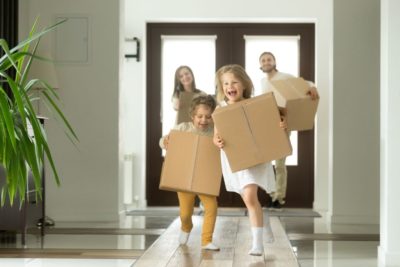 alt="Family moving into new home links to Moving Checklist"