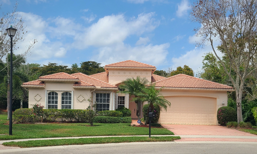 alt="One-story home with a 2-car garage in Valencia Pointe, a Boynton Beach 55+ community."