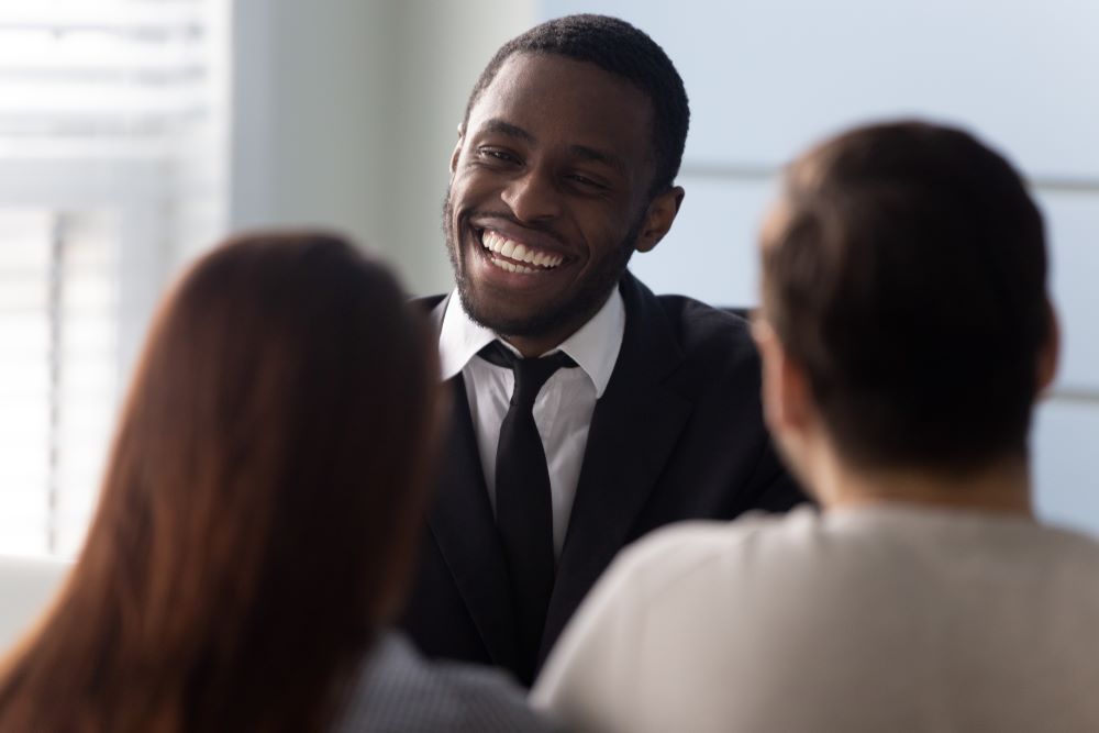 Smiling Realtor helping couple avoid rental scam