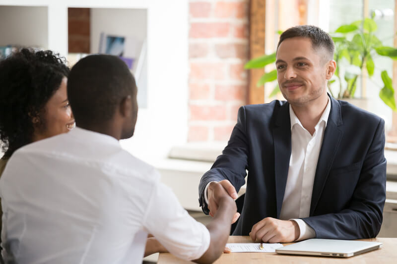 Couple and Realtor negotiating the terms of the listing agreement